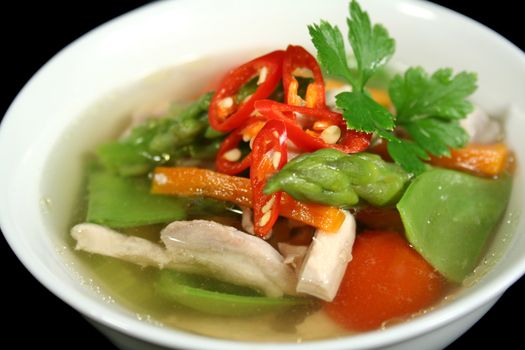 Steaming hot low carb chicken and vegetable soup ready to serve.