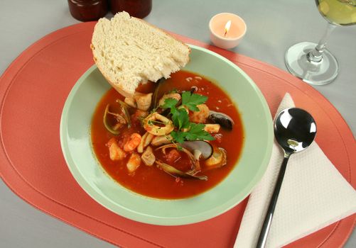 Delicious Mediterranean style tomato seafood soup with a variety of mixed seafood.