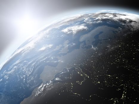 Space view of the sun rising over Europe on blue planet Earth. Elements of this image furnished by NASA.