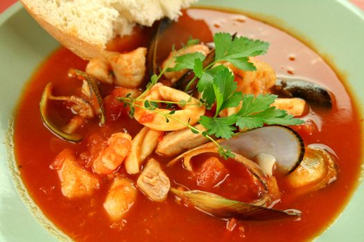 Delicious Mediterranean style tomato seafood soup with a variety of mixed seafood.