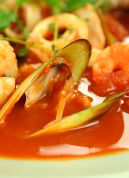 Delicious Mediterranean style tomato seafood soup with a variety of mixed seafood.