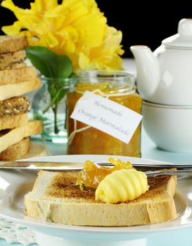 Homemade marmalade on toast with butter ready to serve.