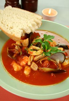 Delicious Mediterranean style tomato seafood soup with a variety of mixed seafood.