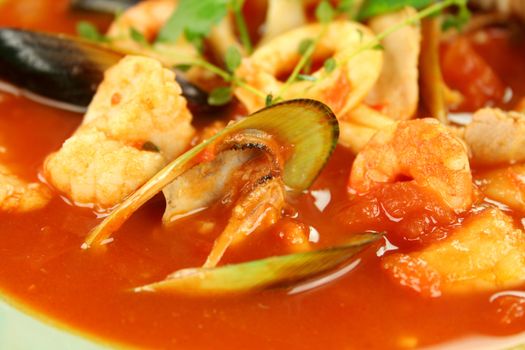 Delicious Mediterranean style tomato seafood soup with a variety of mixed seafood.