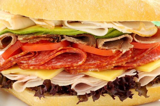 Mega meat roll consisting of ham, salami, roast beef and turkey with cheddar cheese and salad.