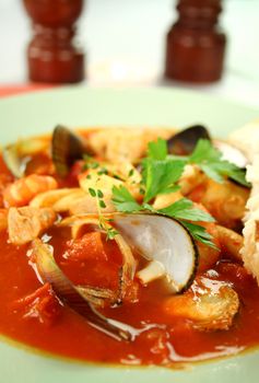 Delicious Mediterranean style tomato seafood soup with a variety of mixed seafood.