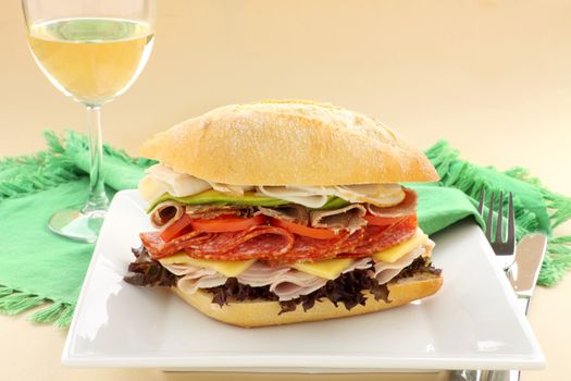 Mega meat roll consisting of ham, salami, roast beef and turkey with cheddar cheese and salad.