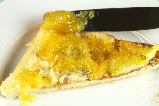 Delicious marmalade jam spread on toast with butter for breakfast.