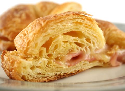 Hot melted cheese and ham croissant ready to serve.