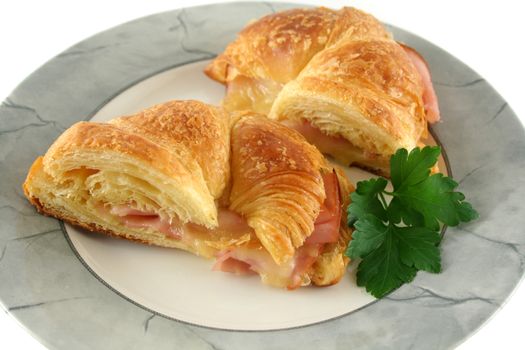 Hot melted cheese and ham croissant ready to serve.