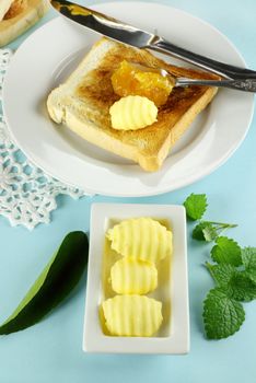 Toast and marmalade with fresh butter scrolls ready to serve.