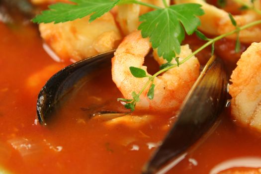 Delicious Mediterranean style tomato seafood soup with mussels and mixed seafood.