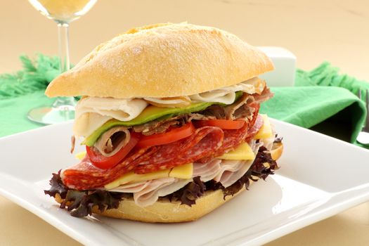 Mega meat roll consisting of ham, salami, roast beef and turkey with cheddar cheese and salad.
