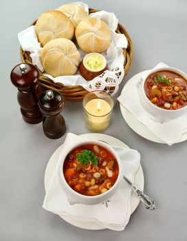 Delicious minestrone soup with fresh baked bread rolls and butter.