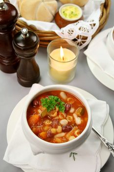 Delicious minestrone soup with fresh baked bread rolls and butter.