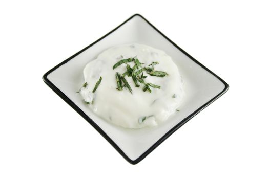 Delicate tray of delicious yoghurt with shredded mint.