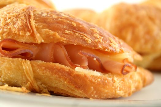 Hot melted cheese and ham croissant ready to serve