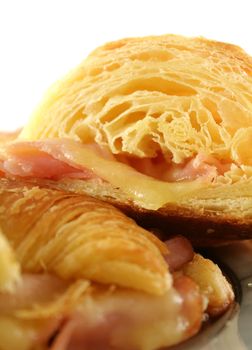 Hot melted cheese and ham croissant ready to serve.