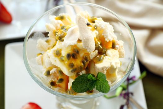 Delicious meringue dessert with pawpaw and passionfruit sauce ready to serve.
