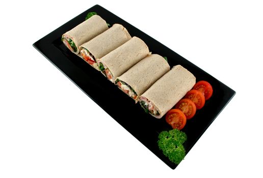 Mixed platter of delicious ham and chicken salad wraps.