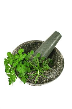 Mortar and pestle with freshly picked garden herbs.