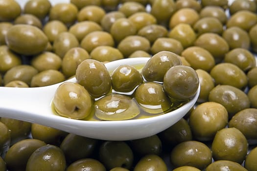 Green olives in a white bucket, a typical product of Andalusia, Spain