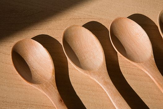 Wooden spoons on table background