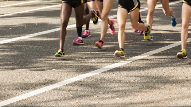 Group of runners on the Road. Motion blurred