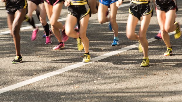 Group of runners on the Road. Motion blurred