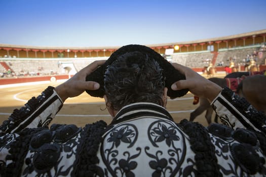 Bullfighter by contacting the montera during a bullfight, Spain