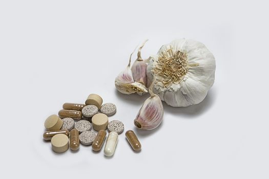 Garlic and herbal supplement pills, alternative medicine concept