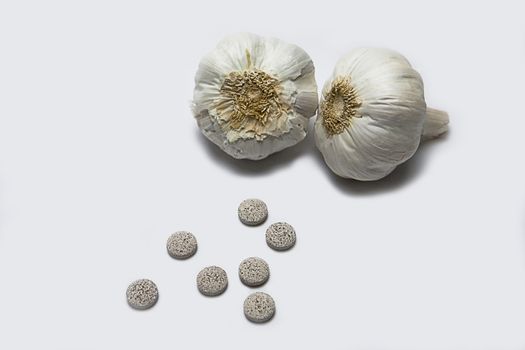 Garlic and herbal supplement pills, alternative medicine concept