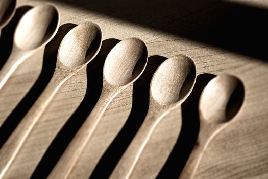 Wooden spoons on table background