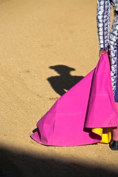 Shadow of a bullfighter by holding the cape in a bullfight, Spain