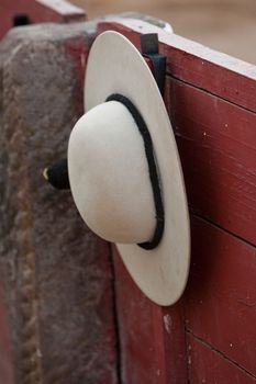 A castoreno (the picador's rounded hat) hanging from the barrier during a bullfight. Linares, province of Jaen, Spain, 30th august 2011