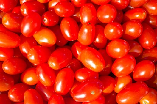 Full frame take of cherry tomatoes displayed on a market stall