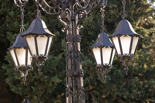 A wrought iron lamp on a weathered wall in 1 First of May Square, Ubeda, province of Jaen, Spain