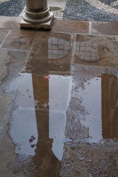 Reflection of a column in a puddle, Palace of the Dean Ortega, National Parador of Ubeda, Jaen province, is one of the paradores oldest in Spain, since it was inaugurated in 1930