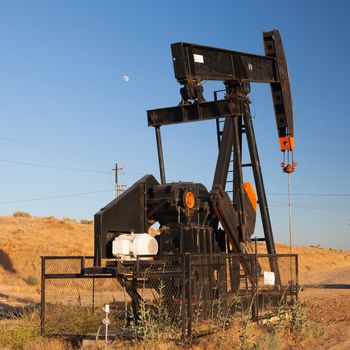 Oil pump in Nevada desert at sunset