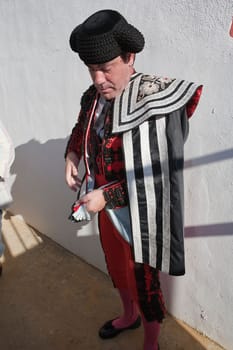 Bullfighters getting dressed for the paseillo or initial parade. Taken at Baeza bullring before a bullfight, Baeza, Spain, 14 august 2010