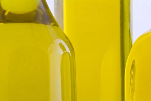 Branch with olives and a bottle of olive oil isolated on white