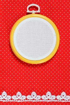 Hoop with a white canvas on a fabric background