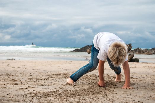 Child playing in sand on the beach