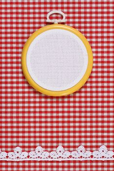 Hoop with a white canvas on a fabric background