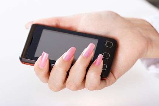 Mobile phone in a female hand. close-up