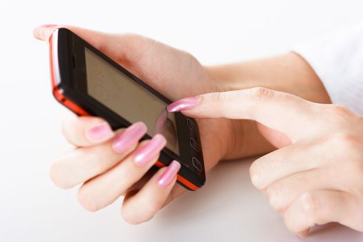 Mobile phone in a female hand. close-up