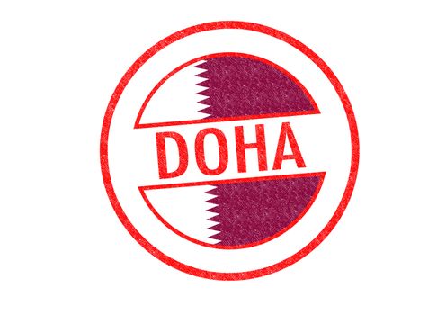 Passport-style DOHA (Qatar) rubber stamp over a white background.