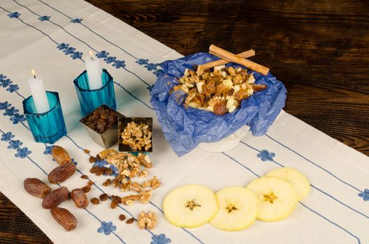 Haroset served on a festive table surrounded by its ingredients