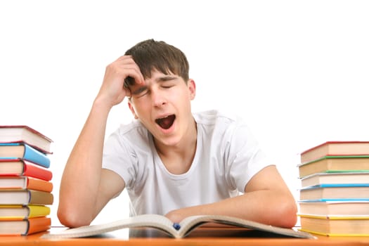 Tired Student Yawning on the School Desk Isolated on the White