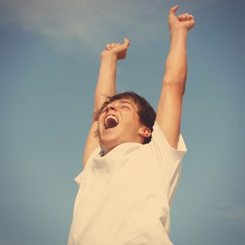 Toned photo of Happy Teenager jumping on sky background